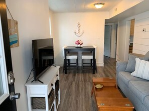 Cozy and inviting living space with a nautical touch and large flat screen tv