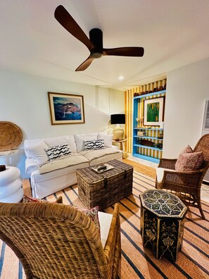The Gathering Room - sleeper sofa, comfy chairs, jute rug, 55” tele, ceiling fan