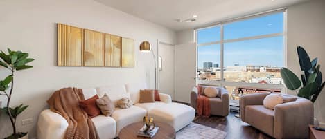Living Room: Bright and modern space with chic decor and stunning city views! Perfect for relaxation.