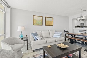 White leather couch expands to queen sofa sleeper for extra guest options,  This direct oceanfront condo boasts stunning views of the resort pools, beach and amazing North Myrtle Beach Sunrises