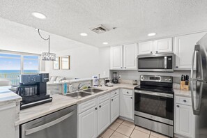This oceanfront kitchen is stocked full with dishwasher, full-sized refrigerator, freezer, microwave stove, oven, blender, sink, drip and k-cup Keurig coffee, dishware, silverware, and cookware. Enjoy memorable vacation meals in this amazing kitchen.