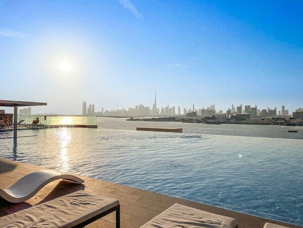 Infinity Pool Retreat: Dive into luxury with skyline views and radiant sunsets!