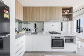 Whip up delicious meals in the fully equipped kitchen, complete with an oven, dishwasher and coffee essentials for your morning ritual.