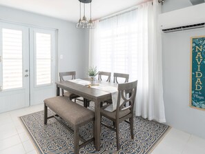 Dining area with air conditioning and direct access to the back patio.
