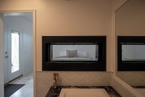 Master suit bath, jetted tub with 2 way fireplace.