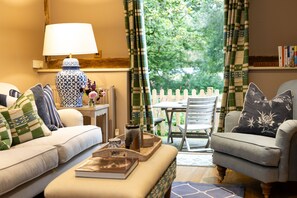 The welcoming, open-plan sitting and dining room with access to the garden
