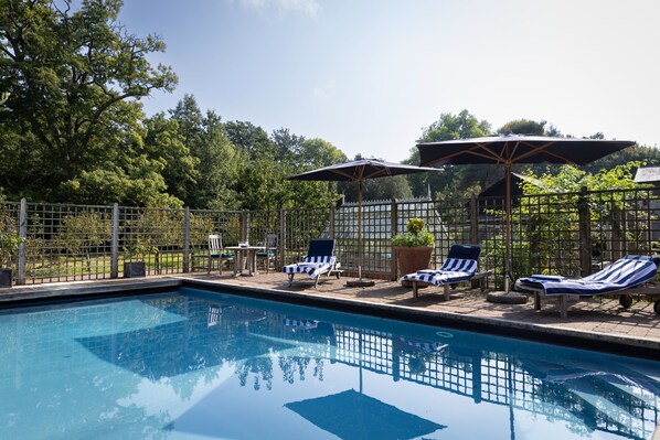 Sun loungers and parasols await your arrival by the outdoor pool