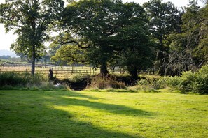 View from the loggia across to the lake (please note, this area of lawn is not accessible to guests of Stable Cottage)
