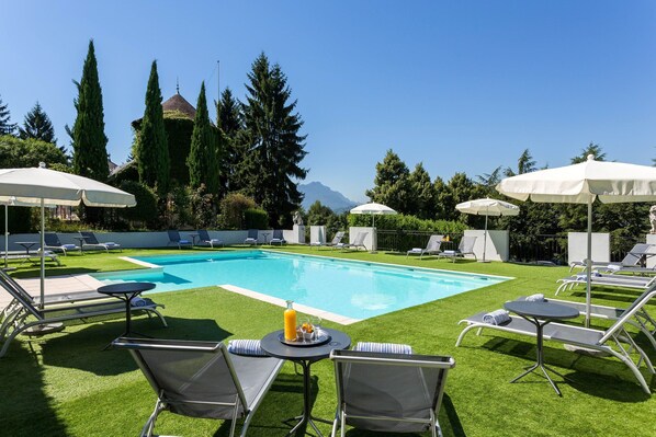 Lounge by the pool in the sunshine.