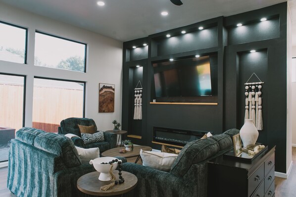 Welcome to your spacious escape in Dallas, Texas! Redpine's modern living room offers the perfect spot to gather in this fantastic 4-bedroom house.