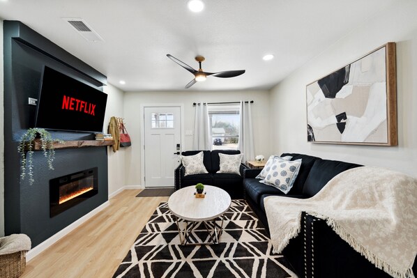 Kick back in this comfy living room with a cozy couch and a big TV, perfect for streaming your favorite shows after a day exploring the Heard Natural Science Museum.