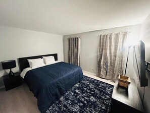 Cozy king bedroom with a closet and Smart Roku TV for your entertainment.