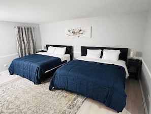 Spacious bedroom featuring two king-size beds for ultimate comfort.