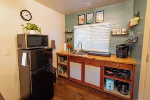 Our kitchenette has a mini fridge, microwave, toaster, Keurig, air fryer, 2 burner stovetop, & basic cooking supplies. Perfect for simple meals not heavy cooking. 