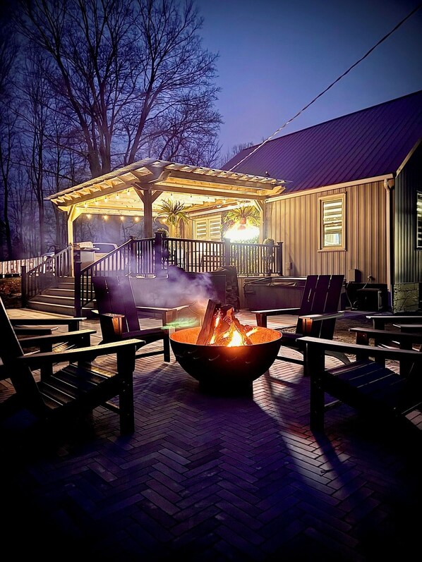 Relax in the hot tub, or gather around the fire pit with provided wood.