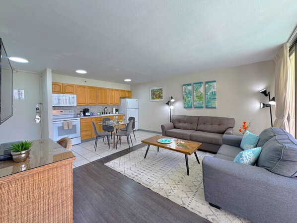 One bedroom with full kitchen, dining area, pull-out sleeper sofa, and flat-screen TV