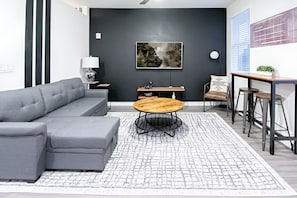 Bright and airy living room with a comfortable sofa and modern decor. Perfect for relaxing after a day of exploring.