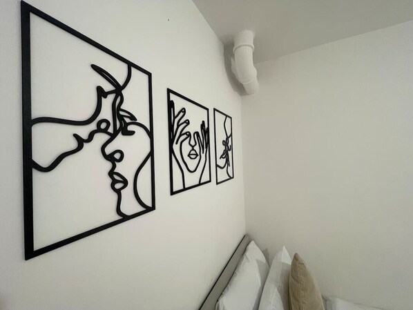 Stunning line art pieces bring a modern and artistic vibe to the space. Perfect for a cosy and stylish bedroom setup