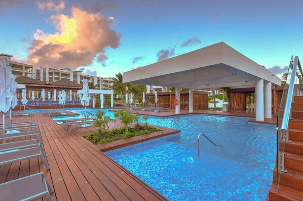 Relax by our resort pool under the stunning evening sky. Unwind and recharge.