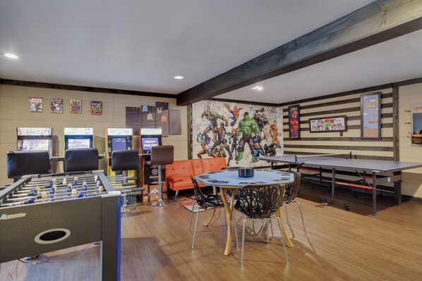 Epic game room with arcade machines, foosball, ping pong, and a poker table—perfect for endless fun and friendly competition!