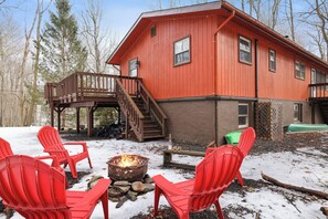 "Cozy outdoor fire pit area with Adirondack chairs—perfect for gathering under the stars, even in winter!