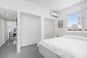 Experience peaceful nights in a generously sized bed, draped in soft, luxurious linens, providing the perfect blend of comfort and sophistication.