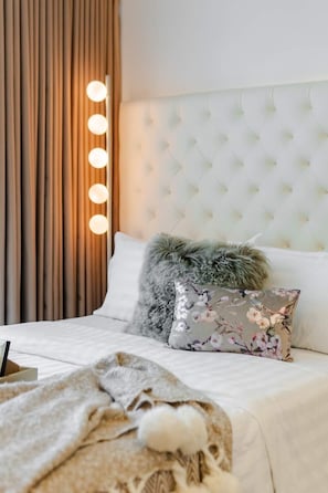 A comfortable, inviting bed with soft linens for a great night's sleep.