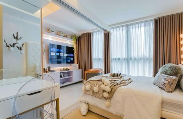 Relax in front of a huge TV. The space is designed for comfort and easy viewing.