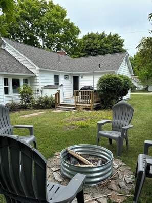 EXTERIOR:  The backyard, backyard deck, and the fire pit in the backyard