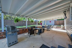 Back patio with TV, gas grill, and gas firepit/table