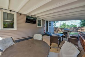 Back patio with TV, gas grill, and gas firepit/table