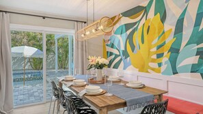 Dine under warm pendant lights with seating for 8 and a colorful Instagram-worthy mural—plus a high chair for your littlest guest.