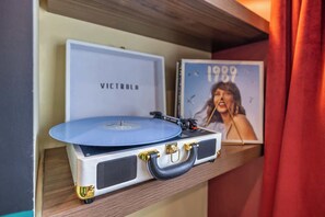 Drop the needle, let the warm crackle of vinyl play, and unwind in the perfect nostalgic moment. Whether reliving classics or discovering new favorites, this record player sets the mood for your stay. 🎧🪩