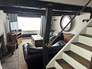 Lounge with orginal beams and a log burner