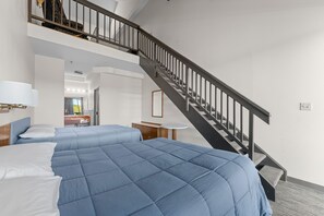 Cozy and spacious loft-style room with plush queen beds, offering comfort and relaxation after a day of adventure.