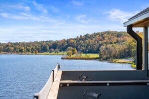 Stunning lakefront views from your private deck, ideal for enjoying a morning coffee or sunset drinks.