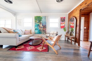 Living spaces that feel so warm, with tons of plants, sunshine, original artwork