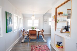 Such a sunny, inviting space for work, meals & connection. 