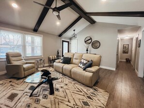 LIVING ROOM boats vaulted ceilings, natural light, multiple cozy seating options