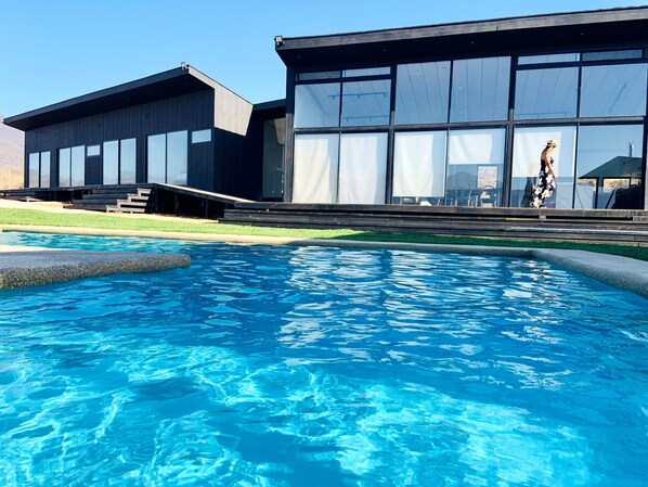 A spacious outdoor grill area overlooking the pool and the breathtaking hills