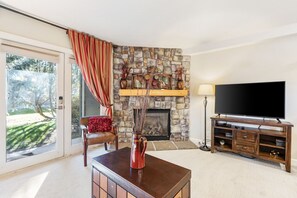 Enjoy the cozy living room, with plush seating and expansive Smart TV.