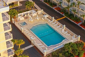 Lounge by the large heated pool surrounded by plenty of seating for sunny days and peaceful evenings