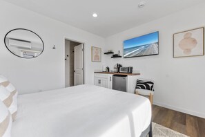 This modern, well equipped kitchenette with a small fridge, microwave, toaster oven/air fryer combo, and Keurig coffee maker -perfect for effortless meals and morning coffee.