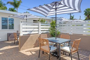 Enjoy your semi-private patio, featuring a table and umbrella, where you can relax and embrace the refreshing ocean breeze.