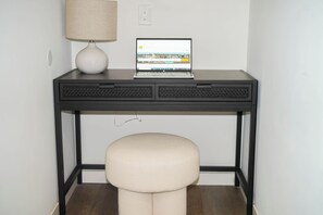 Professional workspace available, featuring a compact desk and chair, ideal for individuals in need of a dedicated work area