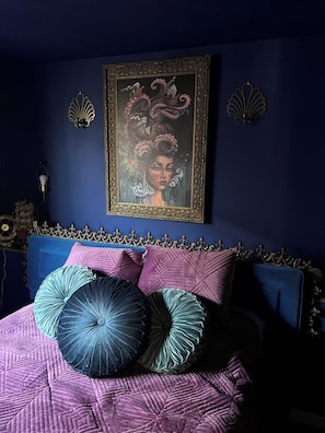 This stunning bedroom, bathed in blues and purples, is a haven for relaxation.