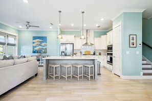 Large kitchen island includes seating for 4.