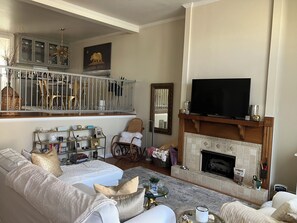 This beautiful, spacious and airy living room features cozy seating & smart tv.