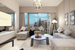 A spacious living room with a huge TV and a stylish coffee table.