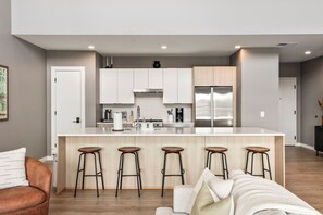 Fully equipped kitchen with modern appliances and ample counter space perfect for cooking a meal. Large island including seating for 5.